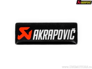 Decalque de substituição - cor base: preto / vermelho / branco - dimensões: 30 x 11 mm - Akrapovič